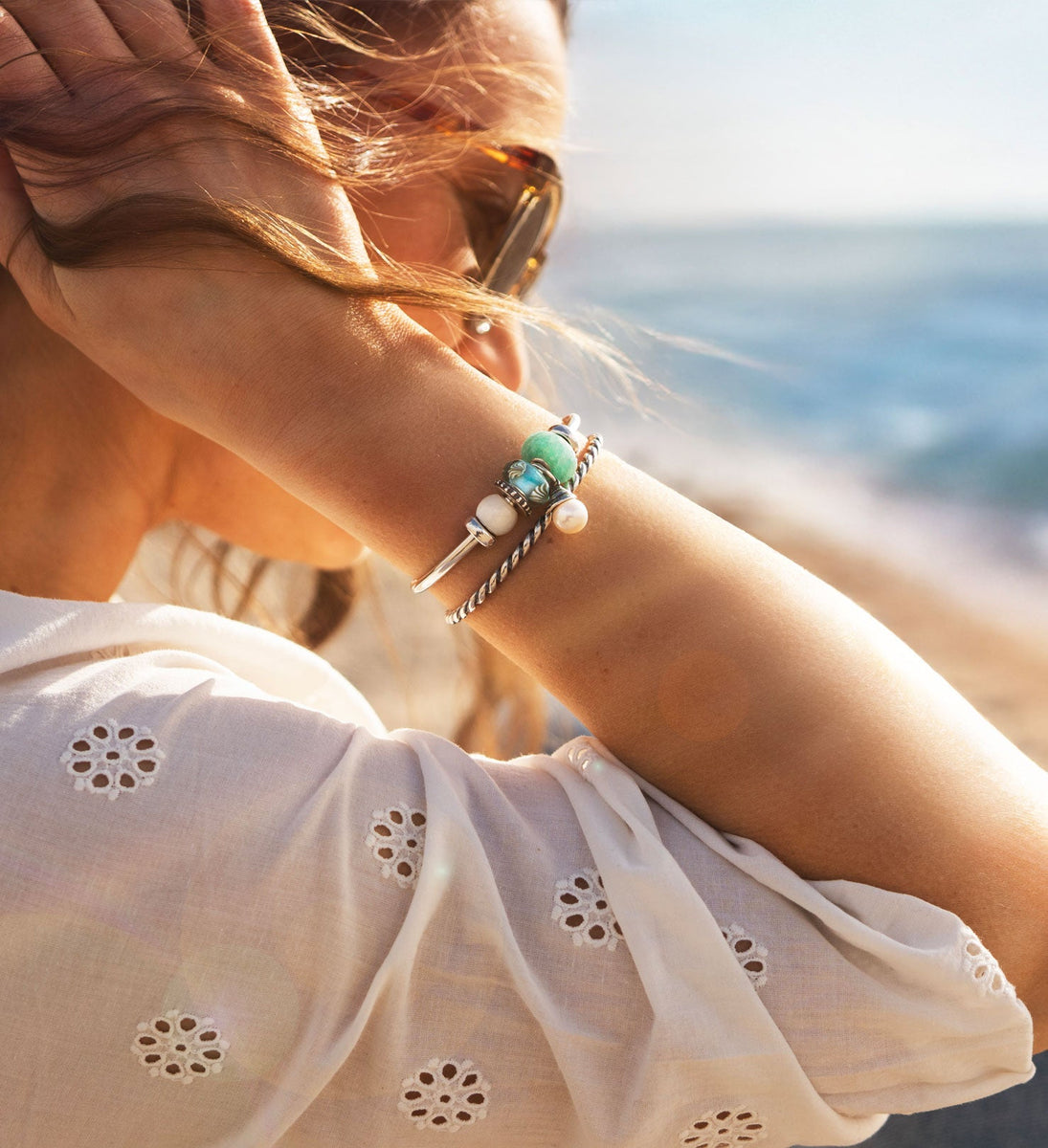 Model with silver bangles and colourful summer beads on beach, Tides of Treasure summer collection 2025, adjusted for mobile